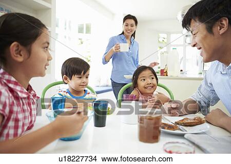 Asian Family Having Breakfast Together In Kitchen View Large Photo Image Picture - Asian Family Having Breakfast Together In Kitchen. Fotosearch