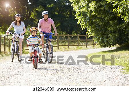 Asian Family On Cycle Ride In Countryside View Large Photo Image Stock Photo - Asian Family On Cycle Ride In Countryside. Fotosearch