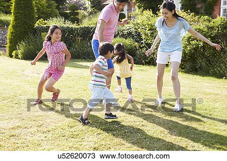 Asian Family Playing In Summer Garden Together View Large Photo Image Stock Image - Asian Family Playing In Summer Garden Together. Fotosearch
