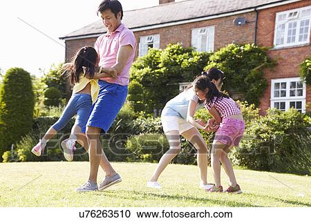 Asian Family Playing In Summer Garden Together View Large Photo Image Stock Image - Asian Family Playing In Summer Garden Together. Fotosearch
