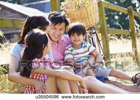Asian Family Resting By Fence With Old Fashioned Cycle View Large Photo Image Stock Photograph - Asian Family Resting By Fence With Old Fashioned Cycle. Fotosearch