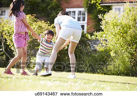 Asian Mother Playing In Summer Garden With Children View Large Photo Image Stock Photo - Asian Mother Playing In Summer Garden With Children. Fotosearch