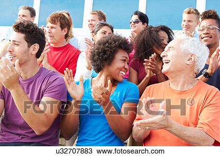 Stock Image - Audience Applauding At Outdoor Concert Performance. Fotosearch
