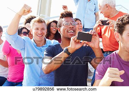 Stock Photograph - Audience Cheering At Outdoor Concert Performance. Fotosearch
