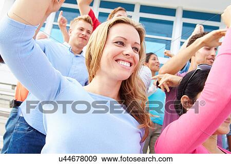 Stock Photo - Audience Dancing At Outdoor Concert Performance. Fotosearch