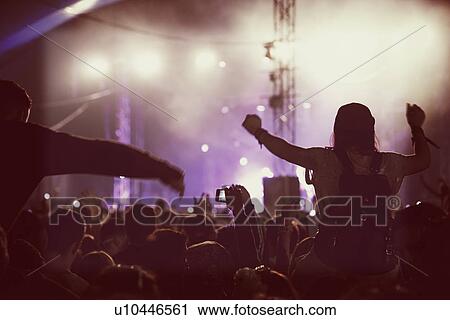 Stock Image - Audience Enjoying Themselves Music Concert. Fotosearch