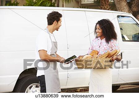 Bakers Using Digital Tablet Unloading Bread From Van View Large Photo Image Stock Photo - Bakers Using Digital Tablet Unloading Bread From Van. Fotosearch