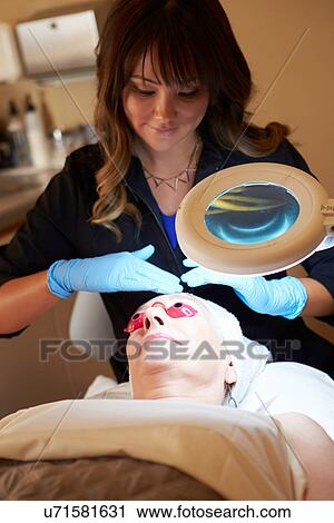 Beautician Applying Cream To Female Client In Clinic View Large Photo Image Stock Image - Beautician Applying Cream To Female Client In Clinic. Fotosearch