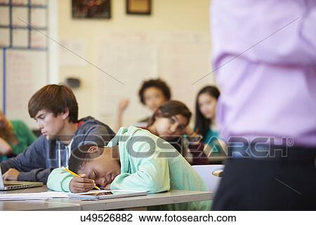Bored High School Pupil Slumped On Desk In Classroom View Large Photo Image Stock Image - Bored High School Pupil Slumped On Desk In Classroom. Fotosearch