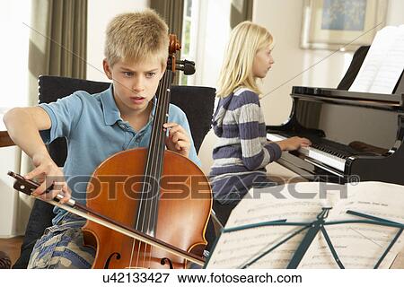 Boy and girl playing cello and piano at home View Large Photo Image Stock Photo - Boy and girl playing cello and piano at home. Fotosearch