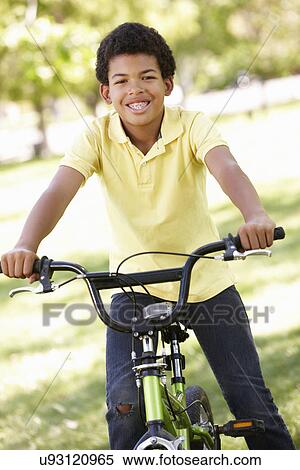 Stock Photography - Boy cycling in park. Fotosearch