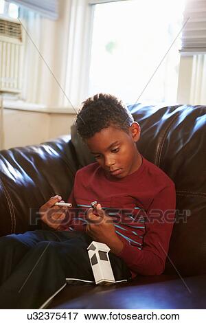 Boy Discovering Parent's Pack Of Cigarettes At Home View Large Photo Image Stock Photo - Boy Discovering Parent's Pack Of Cigarettes At Home. Fotosearch