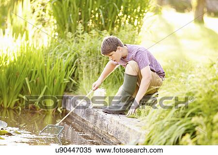 Stock Photography - Boy Fishing In Pond With Net And Jar. Fotosearch
