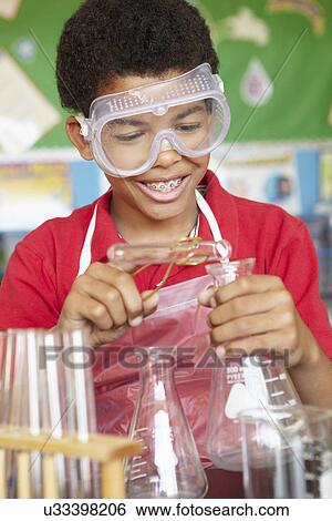 Boy in chemistry class View Large Photo Image Stock Photograph - Boy in chemistry class. Fotosearch