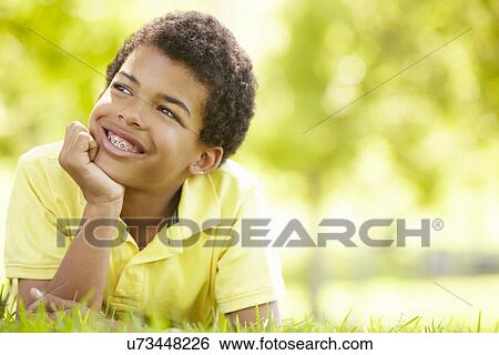 Boy in park portrait View Large Photo Image Stock Photograph - Boy in park portrait. Fotosearch