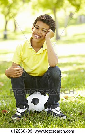 Boy in park with football View Large Photo Image Stock Image - Boy in park with football. Fotosearch