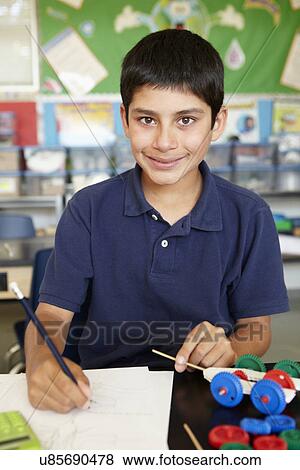 Boy in physics class View Large Photo Image Stock Photo - Boy in physics class. Fotosearch