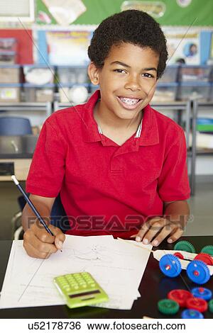 Stock Photograph - Boy in physics class. Fotosearch
