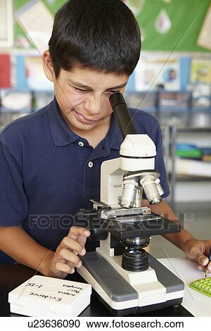 Boy in science class with microscope View Large Photo Image Stock Image - Boy in science class with microscope. Fotosearch