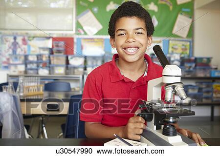 Boy in science class with microscope View Large Photo Image Stock Image - Boy in science class with microscope. Fotosearch