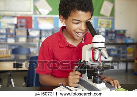 Boy in science class with microscope View Large Photo Image Stock Image - Boy in science class with microscope. Fotosearch