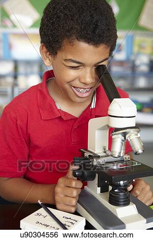Boy in science class with microscope View Large Photo Image Stock Photograph - Boy in science class with microscope. Fotosearch