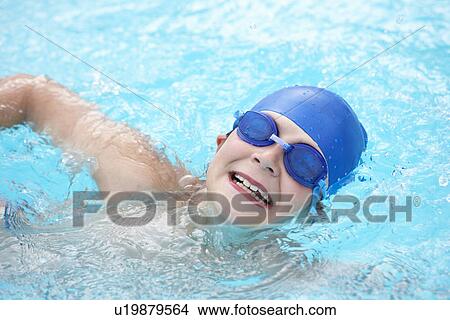 Boy swimming in outdoor pool View Large Photo Image Picture - Boy swimming in outdoor pool. Fotosearch
