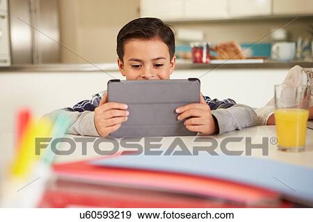 Boy Using Digital Tablet To Do Homework View Large Photo Image Stock Photo - Boy Using Digital Tablet To Do Homework. Fotosearch