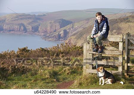 Boy With Dog Walking Along Coastal Path View Large Photo Image Stock Image - Boy With Dog Walking Along Coastal Path. Fotosearch