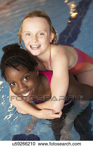 Stock Image - Boys in swimming pool. Fotosearch