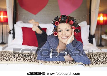 Stock Photo - Bride Getting Ready For Wedding With Hair In Curlers. Fotosearch