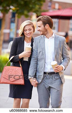 Business Couple Walking Through Park With Takeaway Coffee View Large Photo Image Stock Photography - Business Couple Walking Through Park With Takeaway Coffee. Fotosearch
