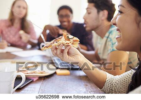 Business People Having Meeting And Eating Pizza View Large Photo Image Stock Photo - Business People Having Meeting And Eating Pizza . Fotosearch