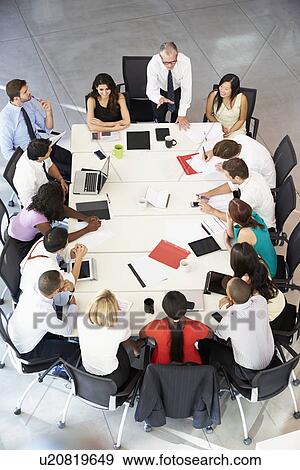 Businessman Addressing Meeting Around Boardroom Table View Large Photo Image Stock Photo - Businessman Addressing Meeting Around Boardroom Table. Fotosearch