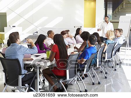 Businessman Addressing Meeting Around Boardroom Table View Large Photo Image Stock Photo - Businessman Addressing Meeting Around Boardroom Table. Fotosearch