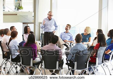 Stock Photography - Businessman Addressing Multi-Cultural Office Staff Meeting. Fotosearch