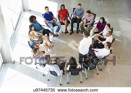 Stock Photography - Businessman Addressing Multi-Cultural Office Staff Meeting. Fotosearch