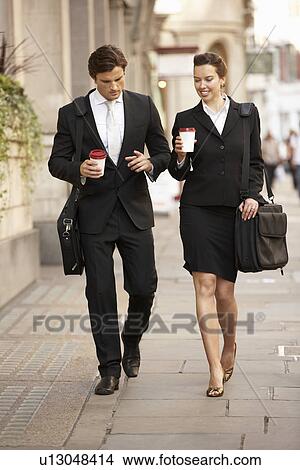 Businessman and businesswoman on their way to work View Large Photo Image Picture - Businessman and businesswoman on their way to work. Fotosearch