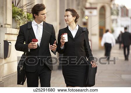 Stock Image - Businessman and businesswoman on their way to work. Fotosearch