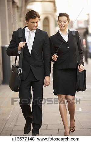 Businessman and businesswoman walking in street View Large Photo Image Stock Photo - Businessman and businesswoman walking in street. Fotosearch