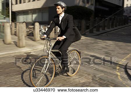 Businessman cycling to work View Large Photo Image Stock Image - Businessman cycling to work. Fotosearch