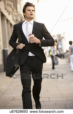 Stock Image - Businessman hurrying to work. Fotosearch