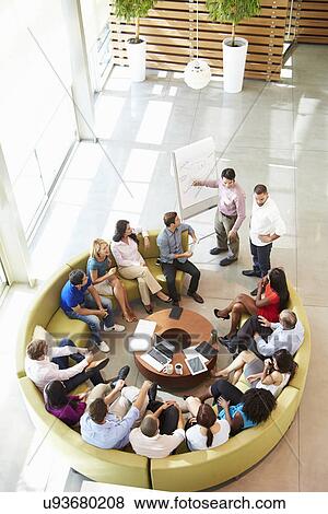 Stock Photo - Businessman Making Presentation To Office Colleagues. Fotosearch