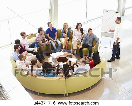 Stock Photograph - Businessman Making Presentation To Office Colleagues. Fotosearch