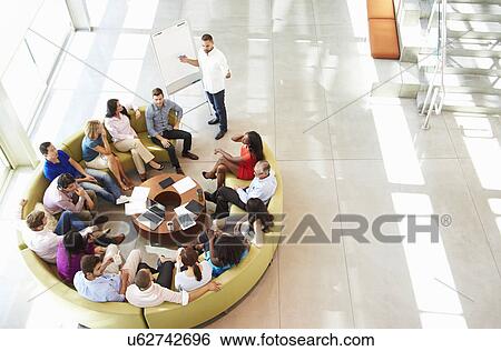 Businessman Making Presentation To Office Colleagues View Large Photo Image Stock Photograph - Businessman Making Presentation To Office Colleagues. Fotosearch