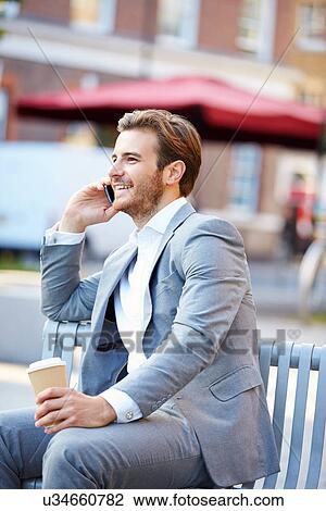 Businessman On Park Bench With Coffee Using Mobile Phone View Large Photo Image Stock Image - Businessman On Park Bench With Coffee Using Mobile Phone. Fotosearch