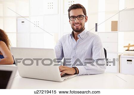 Businessman Using Laptop In Office Of Start Up Business View Large Photo Image Stock Photography - Businessman Using Laptop In Office Of Start Up Business. Fotosearch