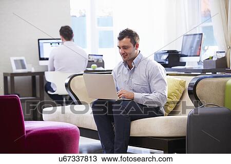 Businessman Working On Laptop In Hotel Lobby View Large Photo Image Stock Image - Businessman Working On Laptop In Hotel Lobby. Fotosearch