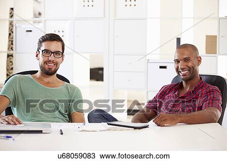 Stock Image - Businessmen Having Discussion In Office Of Start Up Business. Fotosearch
