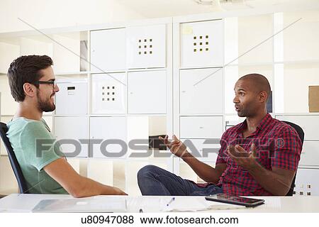 Stock Photo - Businessmen Having Discussion In Office Of Start Up Business. Fotosearch